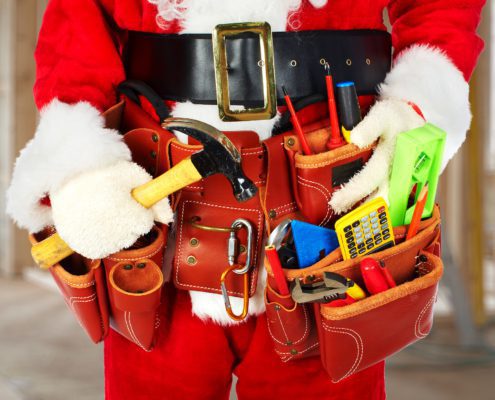 Santa Worker with a tool belt construction background.