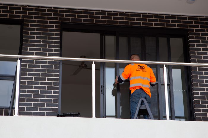 ABM Windows & Doors worker installing sliding door