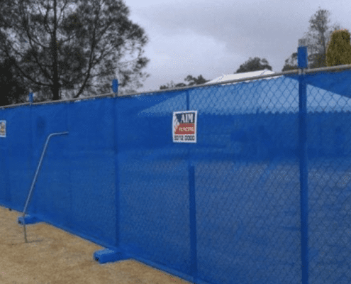 Aim Hire blue fencing around construction perimeter