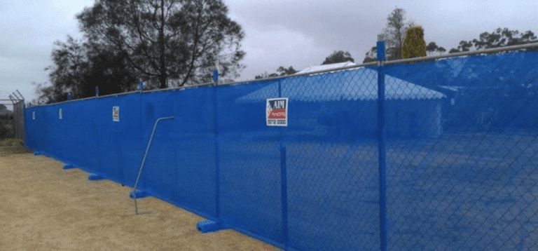 Aim Hire blue fencing around construction perimeter