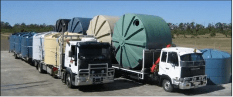 Two trucks loaded with multiple poly water tanks from Capital Tanks