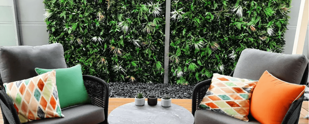 Lounge chair suite against a green garden wall backdrop
