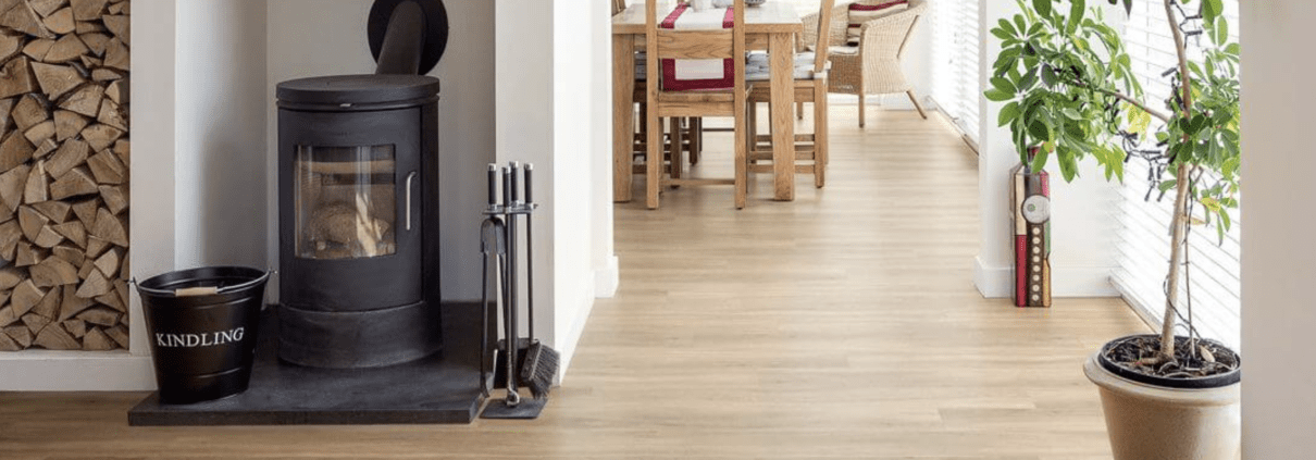 Light timber flooring in a hallway leading to a dining room