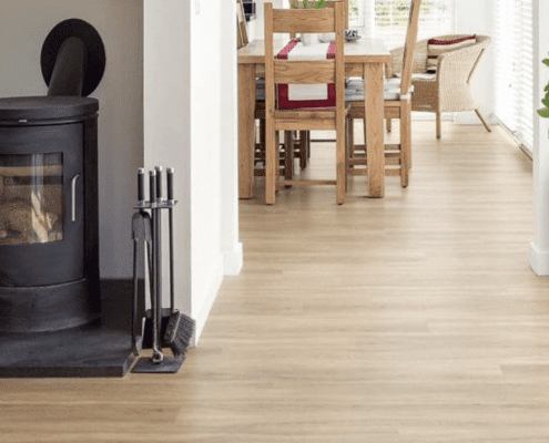 Light timber flooring in a hallway leading to a dining room