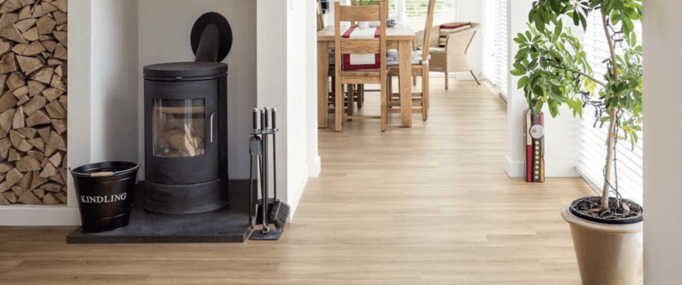 Light timber flooring in a hallway leading to a dining room