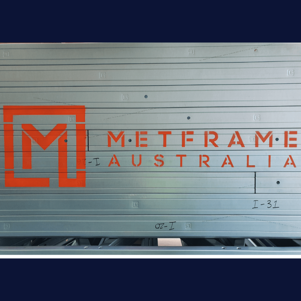 Metal scaffolding with bright orange text and logo stencilled on "Metframe Australia"