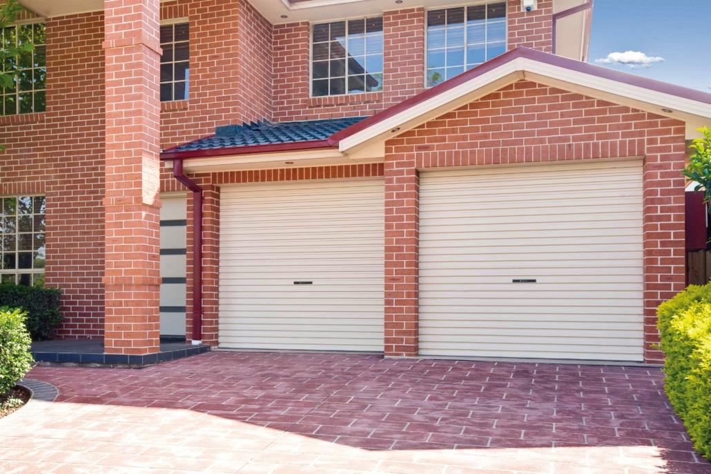 Red brick two story house with paperbark roller garage doors