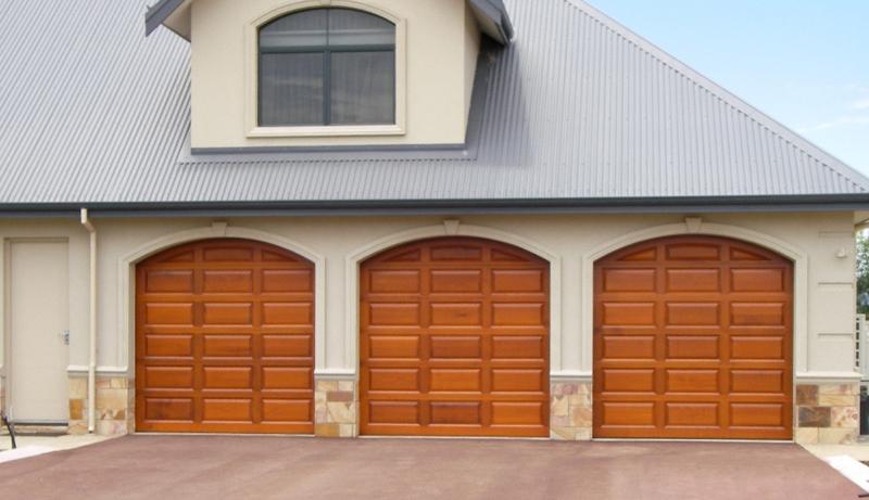 Large 3 door garage with timber look raised panels garage doors from Best Doors