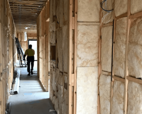 Residential construction house filled with installed insulation