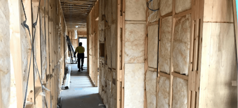 Residential construction house filled with installed insulation