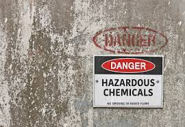 Concrete wall with danger sign “hazardous chemicals”