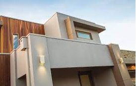 Close up of the external entry way with a mix of neutral concrete toned cladding and warm timber cladding