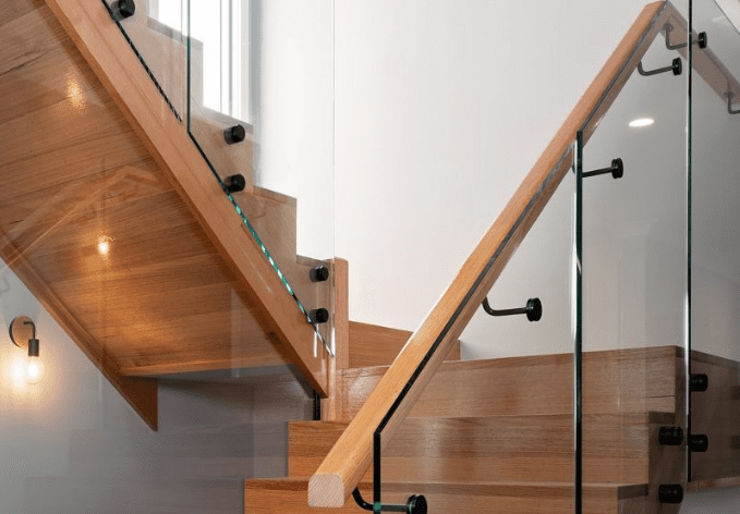 Stair Lock timber stairs with glass balustrade and black hardware
