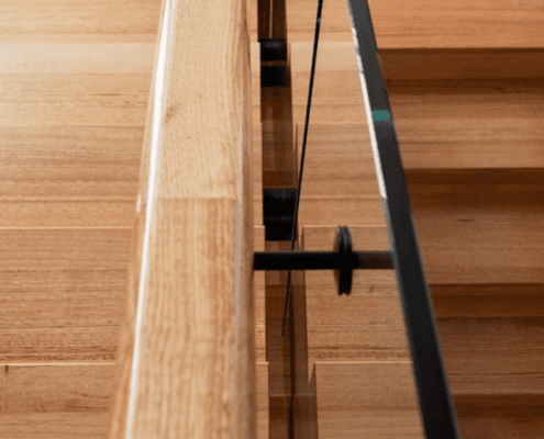 Birds eye view of timber stairs with glass balustrade
