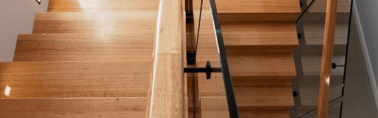 Birds eye view of timber stairs with glass balustrade