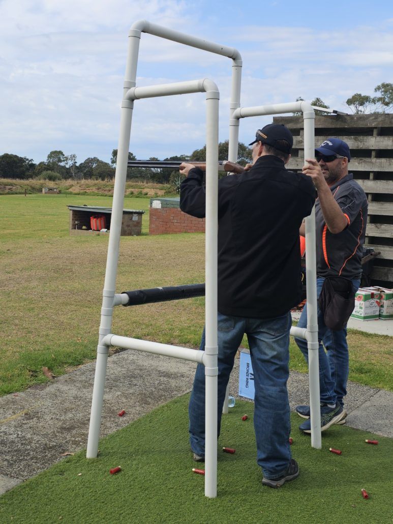 Clay shooting day man and instructor holding gun
