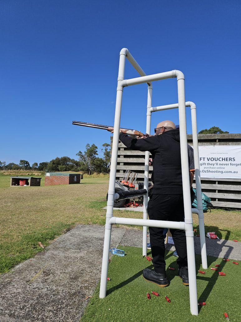 Member aiming gun at the sky at clay shooting day