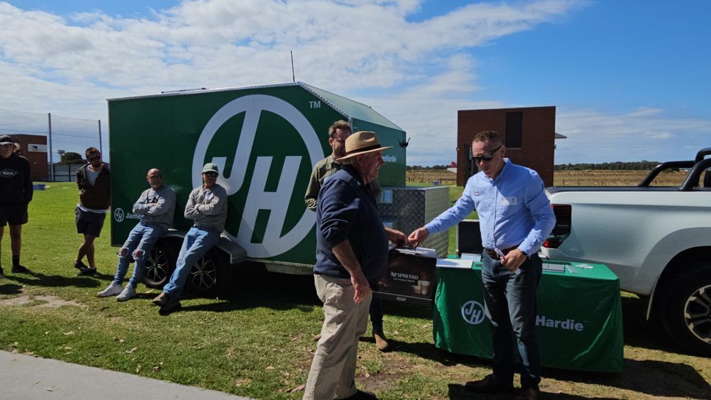 Trade Alliance Group members standing in front of a James Hardie branded ute and trailer