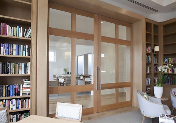 Interior library with floor to ceiling timber framed glass sliding doors