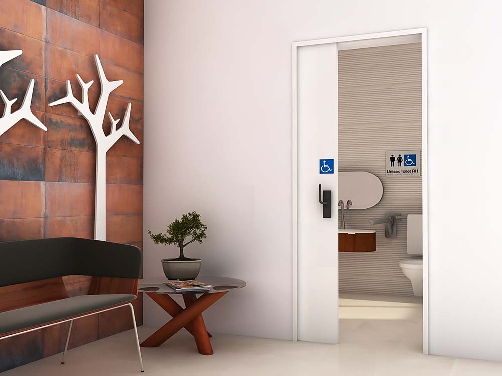 Classy interior commercial bathroom with white timber sliding doors for all access abilities