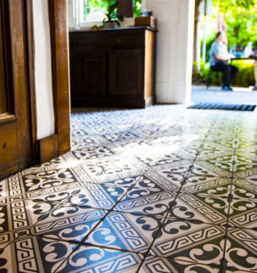 Close up of monochrome swirled pattern tiles in the entryway of a house