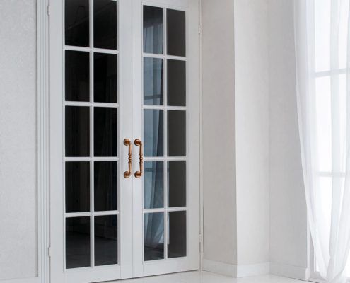 White timber French doors with gold handles