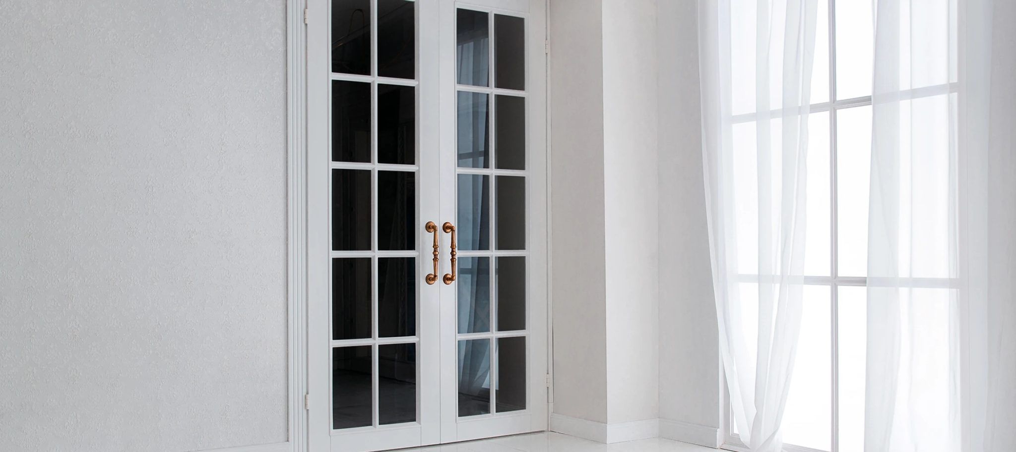 White timber French doors with gold handles