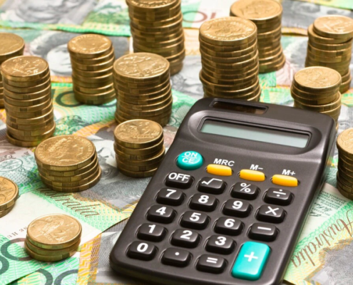 gold coins hundred dollar bills and calculator