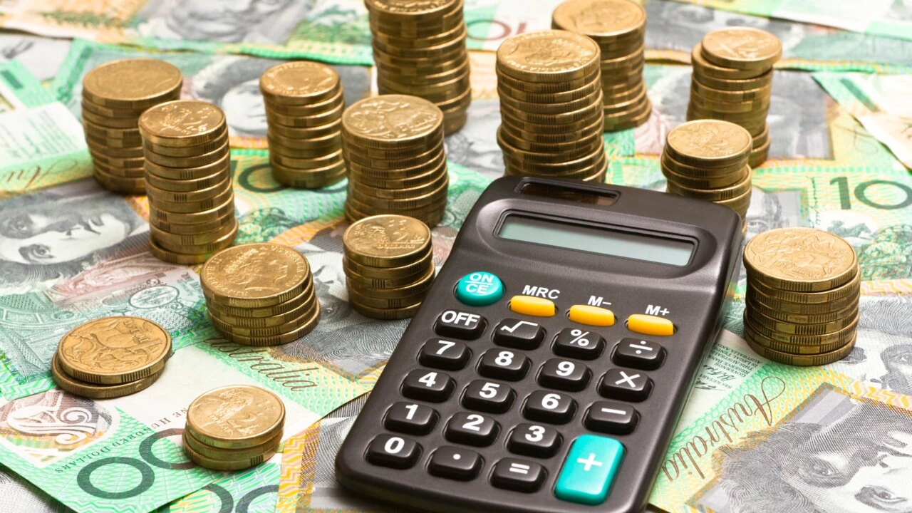 gold coins hundred dollar bills and calculator