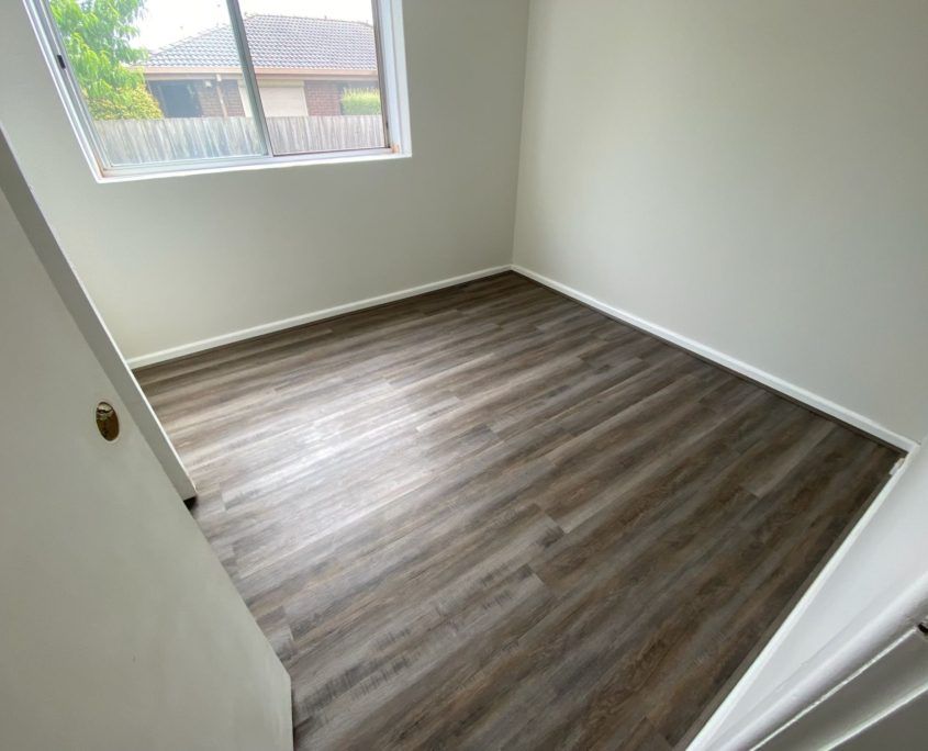 Pride Flooring dark timber floors in bedroom