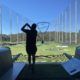 TopGolf TAG event silhouette of player hitting ball