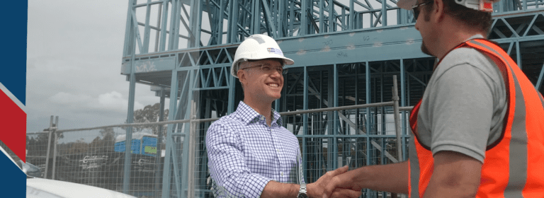 Simon and member outside construction site