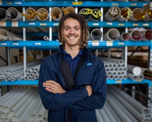 Tradelink feature image worker in front of pipes