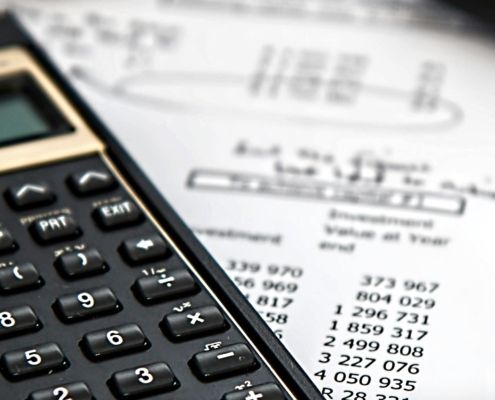 calculator with pen and bills