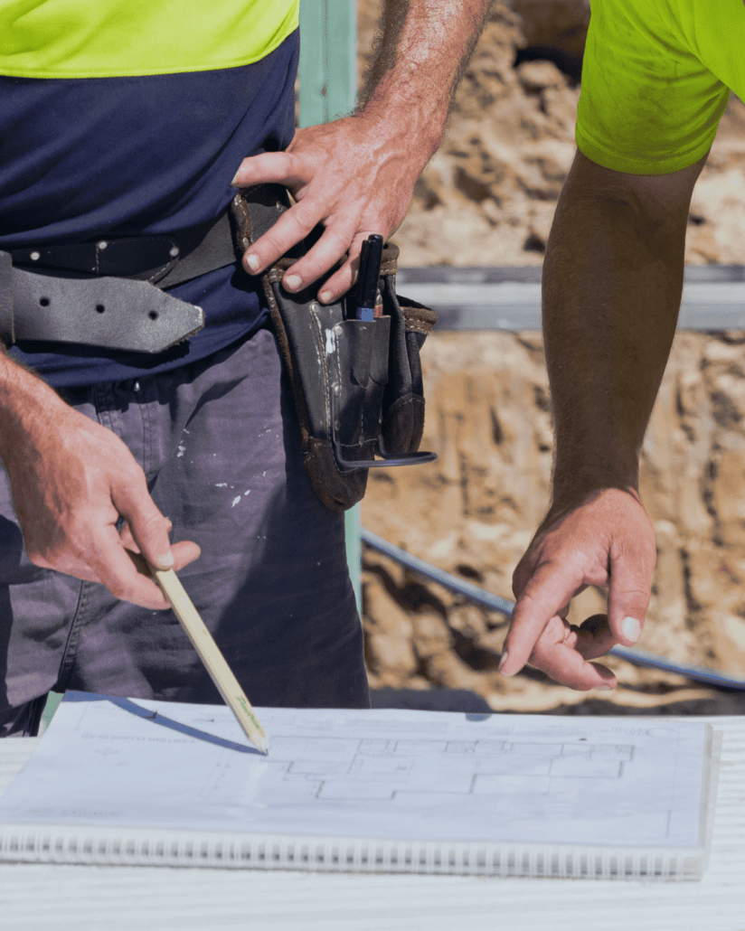 Outsourcing Marketing - two tradies on site with plans