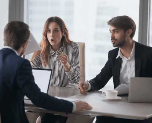 lawyers arguing in office room around board table