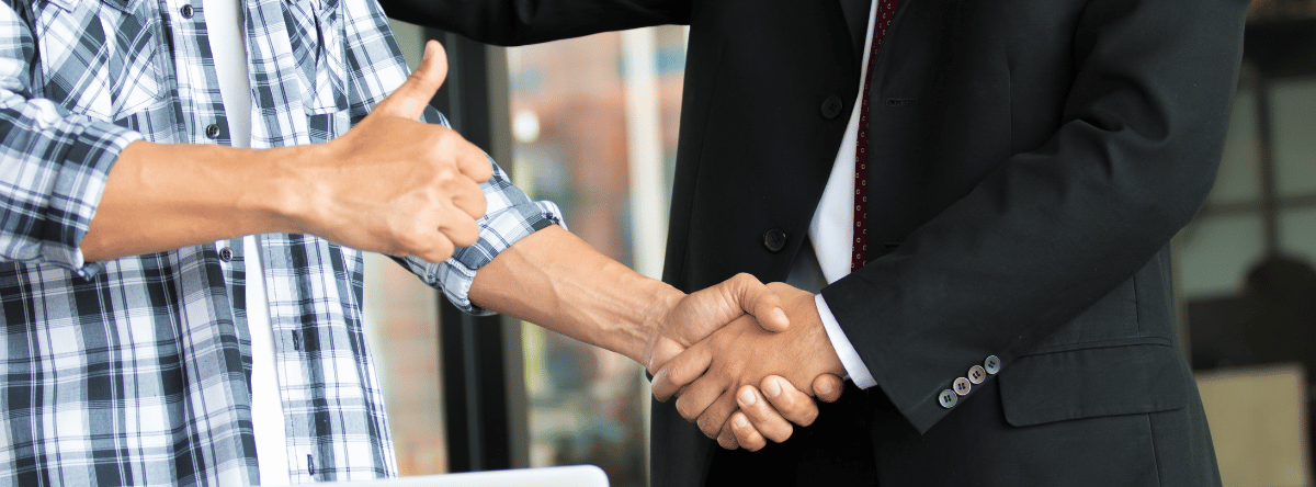 builder shaking hands with a man in a suit after mediation