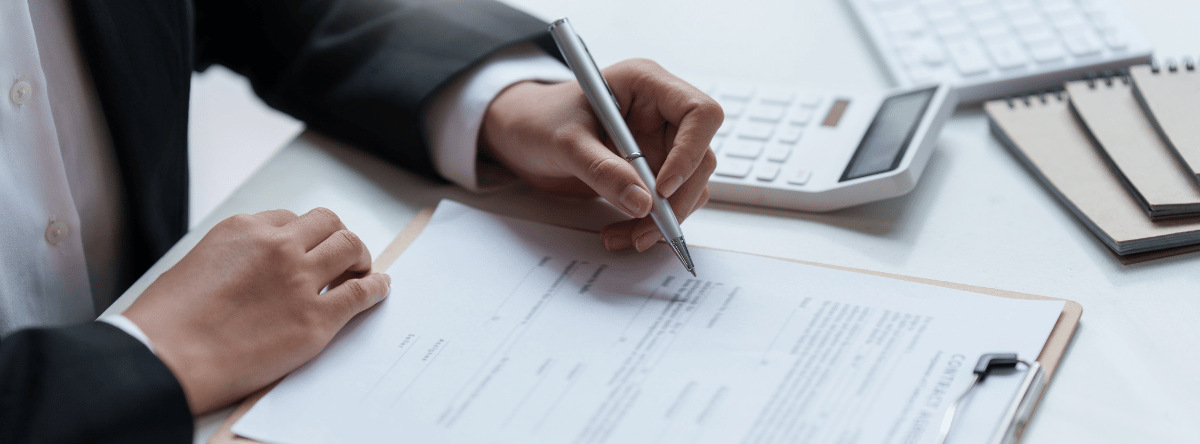 worker at desk doing contract paperwork