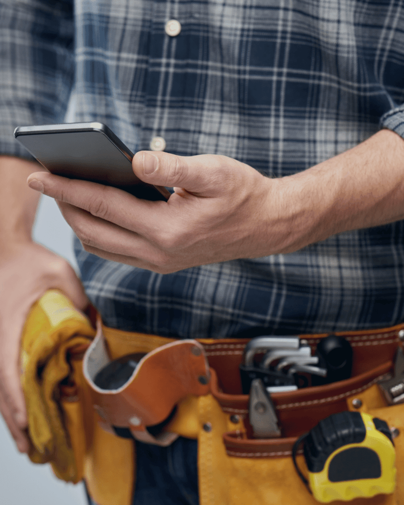 builder with tools and iphone