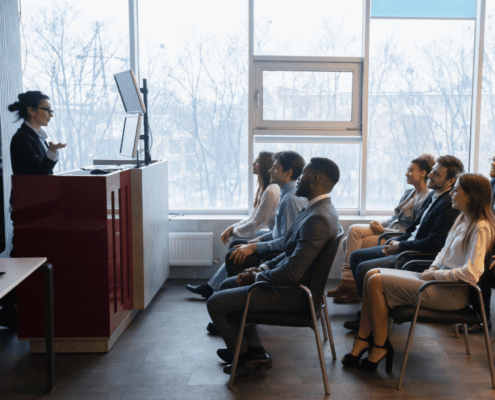 coaching and training staff in a lecture room with someone presenting