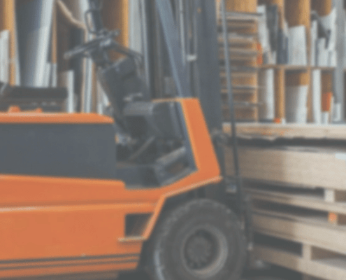 broad traders australia banner forklift in warehouse picking up stack of boards