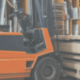 broad traders australia banner forklift in warehouse picking up stack of boards