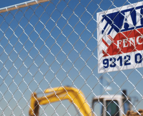 Aim Hire fencing with construction site behind it