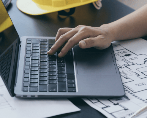 Newsletter Banner builders plans on desk with laptop