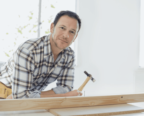 tradie happily working in flannel shirt