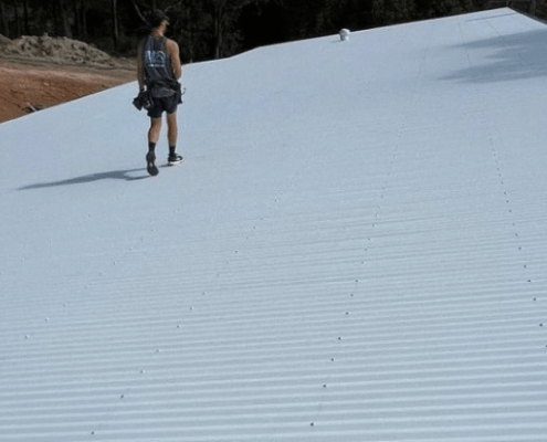 Newsletter Banner BJ roofing metal roofing with employee walking along